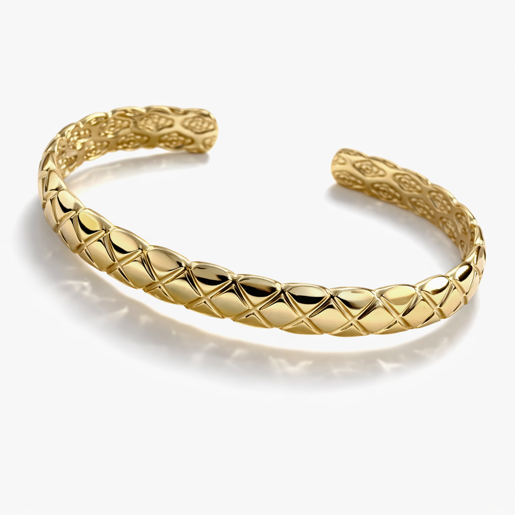 Gold plated textured open cuff bracelet with geometric pattern on white background