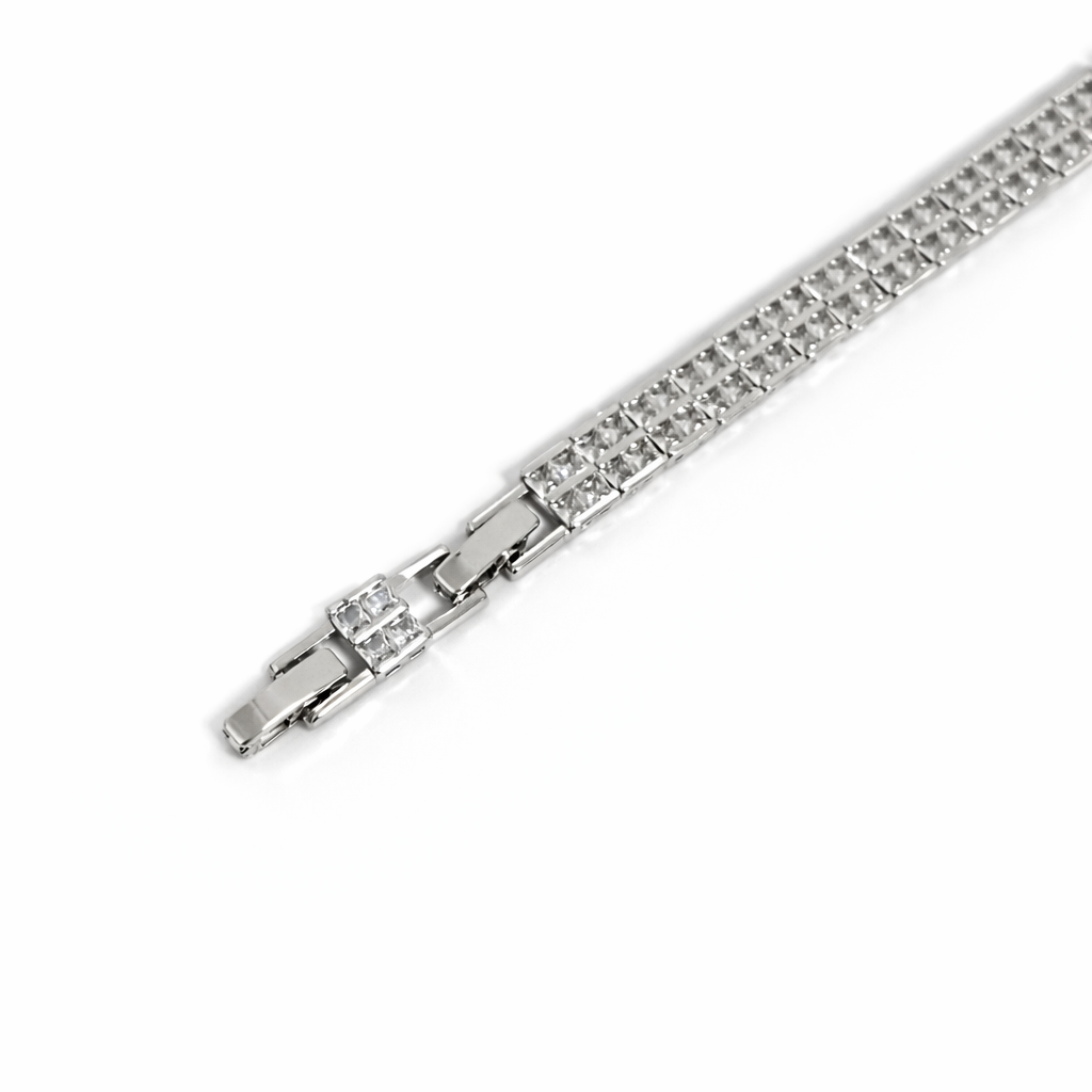 Close view of rhodium plated rectangular link tennis bracelet with double row cubic zirconia stone settings.